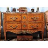 ϒ A kingwood, tulipwood and bois satine serpentine commode, in Louis XV/XVI transitional style