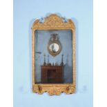 A George I giltwood and gesso girandole wall mirror