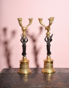 A pair of gilt and patinated bronze three light figural candelabra in Empire taste