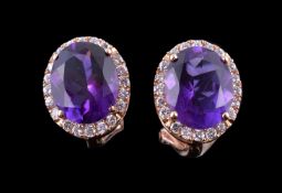 A pair of amethyst and diamond ear studs