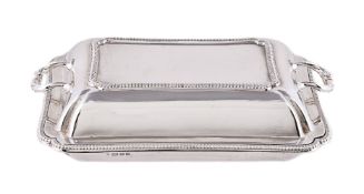 A silver shaped rectangular entree dish and cover