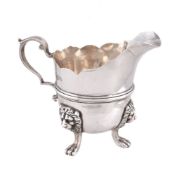 An Edwardian silver helmet shape cream jug by Edward Barnard & Sons Ltd