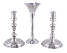 A pair of silver circular candlesticks by John Henry Odell