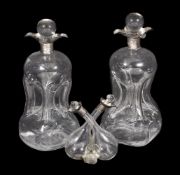 A pair of late Victorian silver mounted glass glug glug decanters by Mappin & Webb (John Newton Mapp