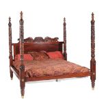 A carved hardwood and stained wood four post bed in Victorian style by Ralph Lauren