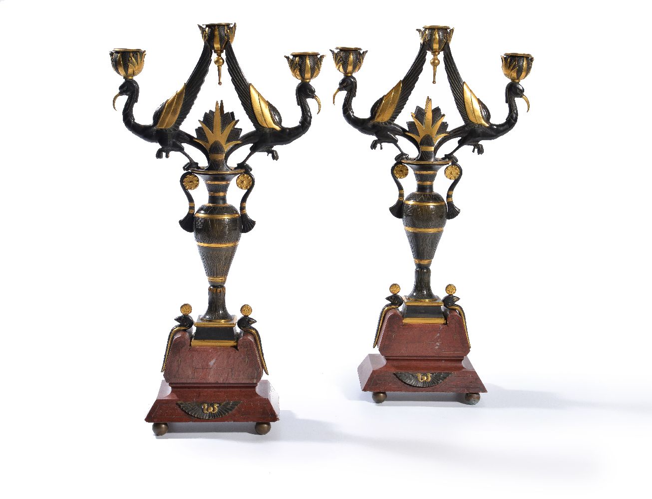 ‡ A pair of French black patinated & parcel gilt bronze three light candelabra