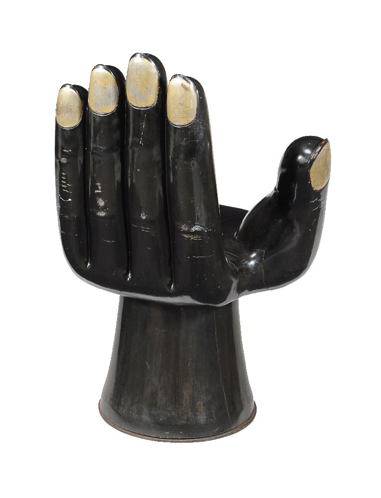 An ebonised hardwood chair in the form of a hand