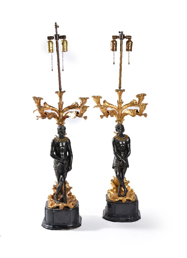 A pair of French parcel gilt and patinated bronze five light figural candelabra