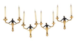 A set of four parcel gilt and patinated bronze twin light figural wall appliques in Régence taste