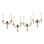 A set of four parcel gilt and patinated bronze twin light figural wall appliques in Régence taste