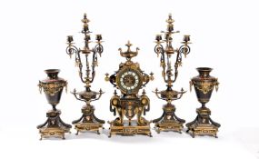 A French parcel gilt and patinated bronze and black slate clock garniture in the Roman Revival taste