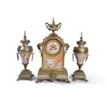 ‡ A silvered and parcel gilt brass porcelain mounted clock garniture in the Oriental taste