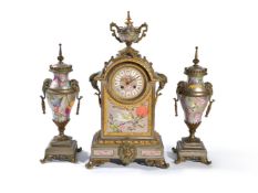 ‡ A silvered and parcel gilt brass porcelain mounted clock garniture in the Oriental taste