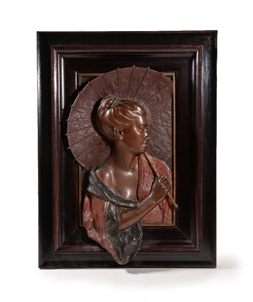 A cast and polychrome painted spelter relief of a geisha cast after a model by Louis Hottot