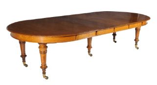 A Victorian oak extending dining table by Howard & Sons