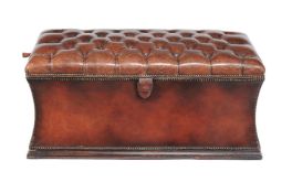 A buttoned and studded leather upholstered ottoman