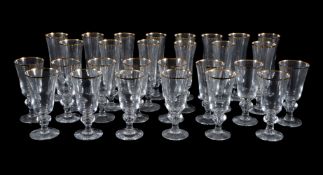 Fourteen modern Dartington Glass slender champagne glasses with gilt-line rims