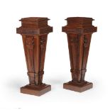 ‡ A pair of carved walnut pedestals