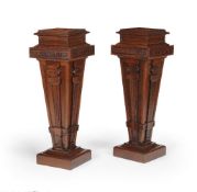 ‡ A pair of carved walnut pedestals