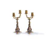 ‡ A pair of gilt and silvered metal twin light candelabra in Chinoiserie taste