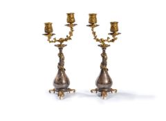 ‡ A pair of gilt and silvered metal twin light candelabra in Chinoiserie taste