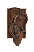 A cast and polychrome painted spelter profile relief of a Japanese man cast after a model by Louis H