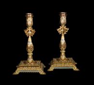 ‡ A pair of French champlevé enamelled and gilt metal candlesticks in the Persian taste
