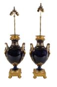 A pair of French gilt metal mounted ceramic table lamps