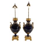 A pair of French gilt metal mounted ceramic table lamps