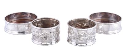 A pair of silver wine coasters by S. J. Phillips Ltd