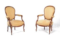 ϒ A pair of Victorian solid rosewood and upholstered armchairs