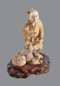 ϒ A Japanese Ivory Okimono of a Peasant