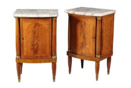 A pair of French mahogany and marble topped bedside cupboards