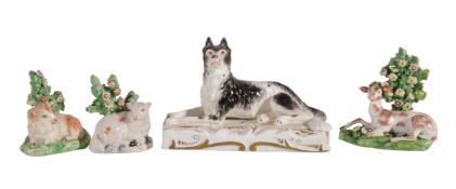 A Staffordshire porcelain model of a recumbent hound and other items