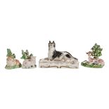 A Staffordshire porcelain model of a recumbent hound and other items