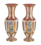 A pair of Bohemian ruby glass and opaque-white overlay baluster vases