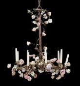 A Continental wrought metal and porcelain nine light chandelier