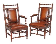 A pair of Reformed Gothic walnut and leather upholstered armchairs