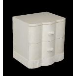 A simulated ivory bedside cabinet