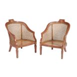 A pair of gilt and red lacquer bergere armchairs in Regency style