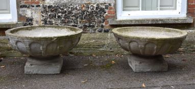 A pair of stone composition garden urns