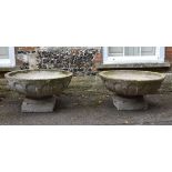 A pair of stone composition garden urns