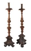 A pair of continental carved and stained wood altarsticks