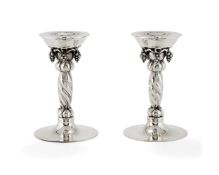 Georg Jensen, a pair of Danish silver Grape pattern candlesticks