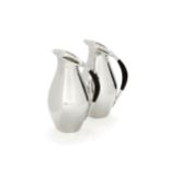 Georg Jensen, a pair of Danish silver water jugs or pitchers