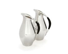 Georg Jensen, a pair of Danish silver water jugs or pitchers