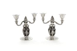 Georg Jensen, a pair of Danish silver Fir Cone twin light candelabra