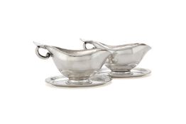 Georg Jensen, a pair of Danish silver sauce or gravy boats on integral stands