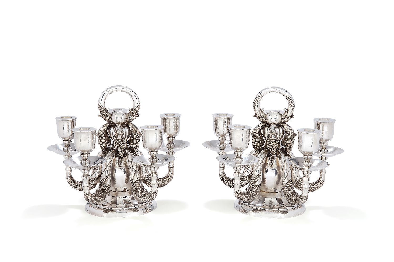 Georg Jensen, a pair of Danish silver Grape pattern candelabra
