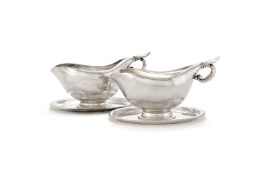 Georg Jensen, a pair of Danish silver sauce or gravy boats on integral stands
